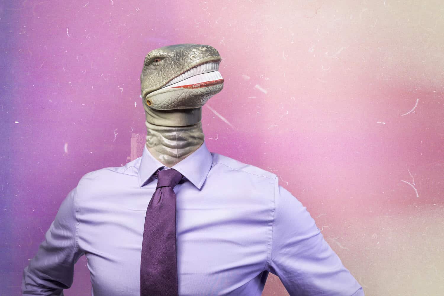Photo of a dinosaur head wearing a suit and tie